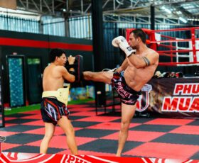 Two persons fighting muay thai